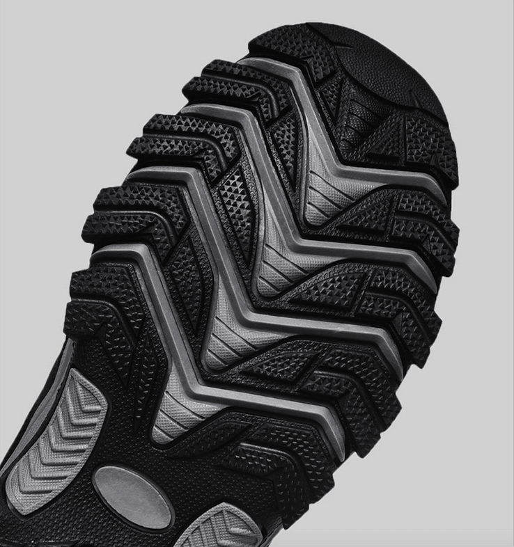 Close-up of non-slip hiking shoe tread showcasing multi-directional grip pattern for superior traction. Ideal for outdoor adventures.