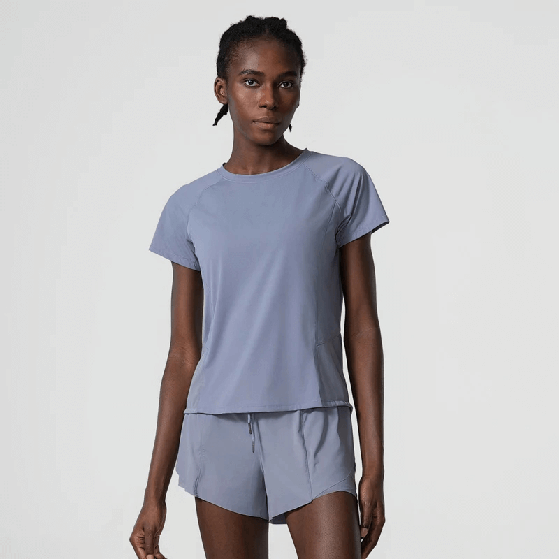 Woman in breathable nylon gym wear for yoga and running, featuring quick-dry short sleeves and solid pattern, SF2081 model.