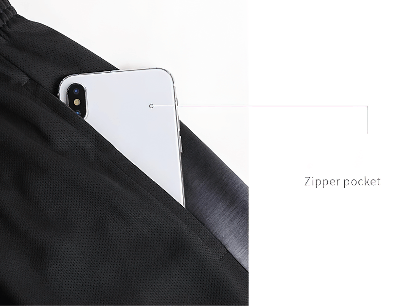 Close-up of black sports shorts with a convenient zipper pocket, holding a smartphone partially visible.