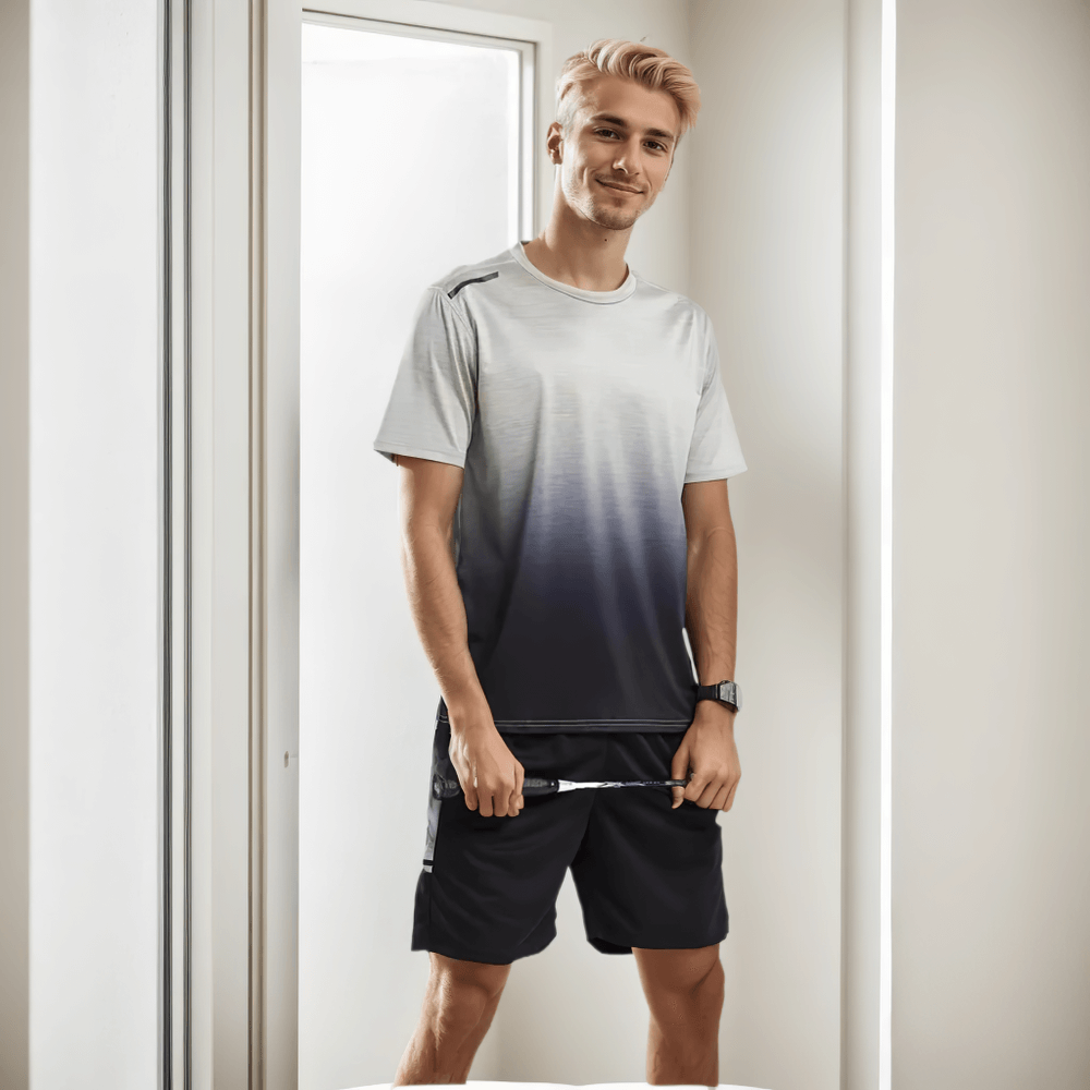 Man wearing a breathable o-neck tee and shorts set, showing stylish gradient print. Perfect sportswear for active lifestyles, quick-dry fabric.