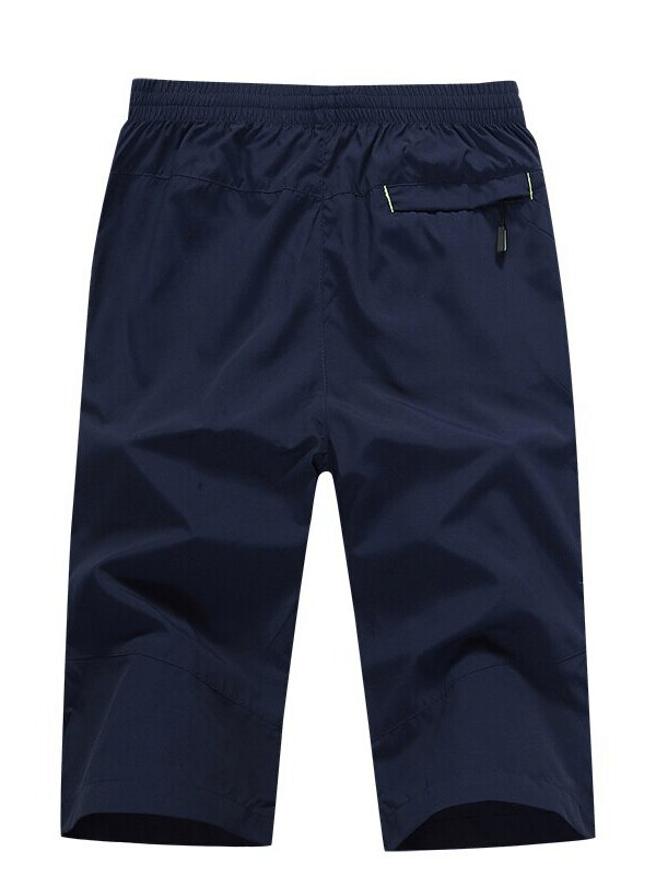 Back view of men's breathable quick dry shorts with zipper pockets and elastic waistband, navy blue color.