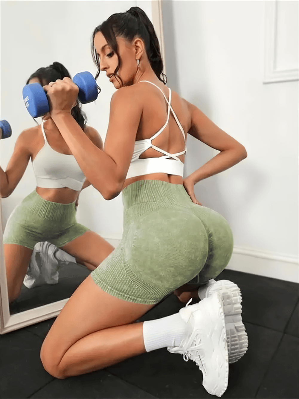 Woman wearing Breathable Scrunch Seam Gym Cycling Shorts - SF4153 in light green while exercising with dumbbells