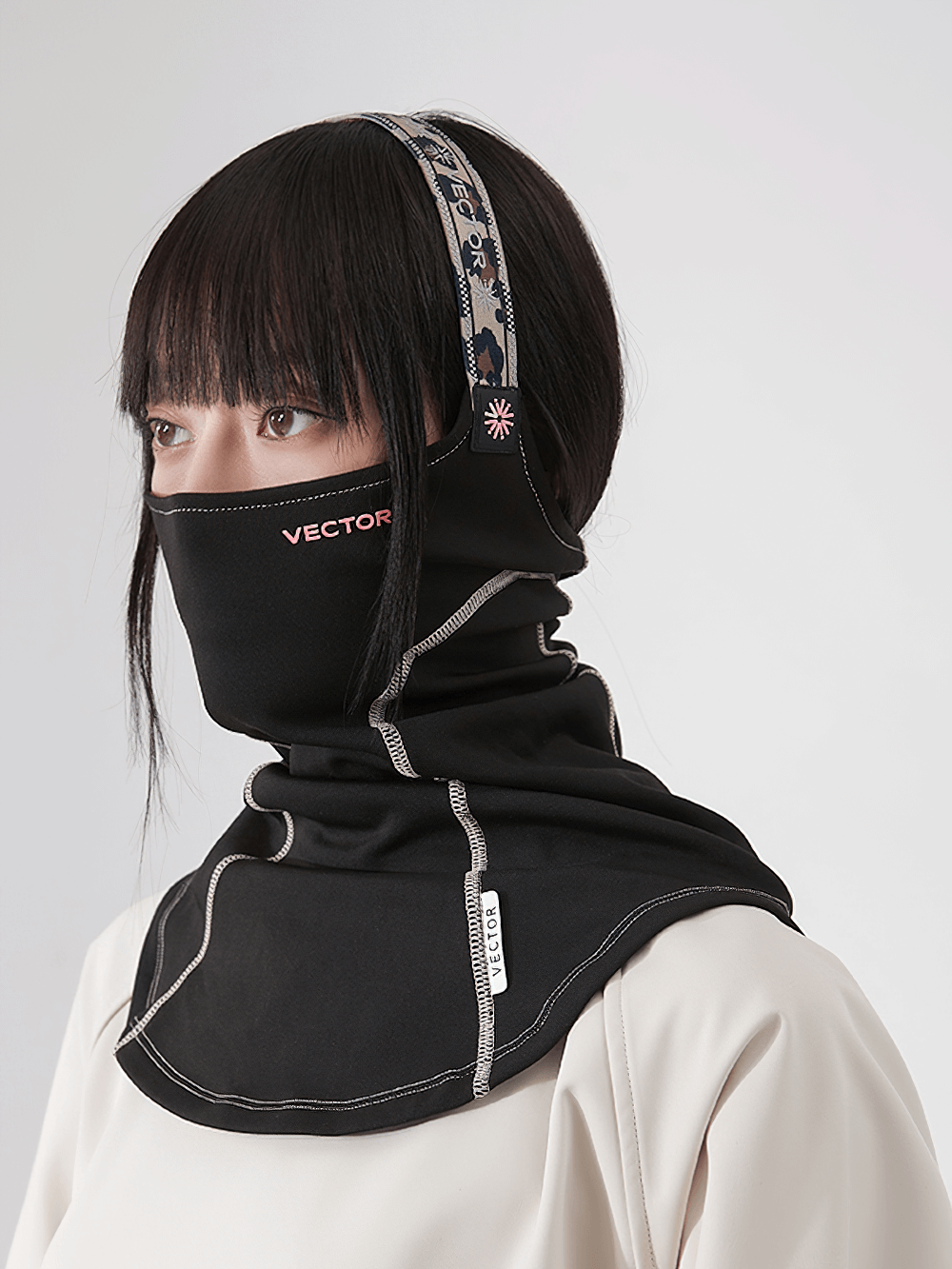 Breathable ski and snowboard half-face mask scarf, black, worn by a model. Perfect for skiing, snowboarding, or motorcycling.