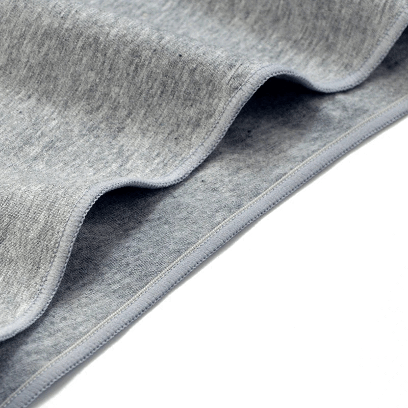 Close-up of soft gray cotton fabric texture, highlighting the breathable and sleek design of women's low-rise briefs.
