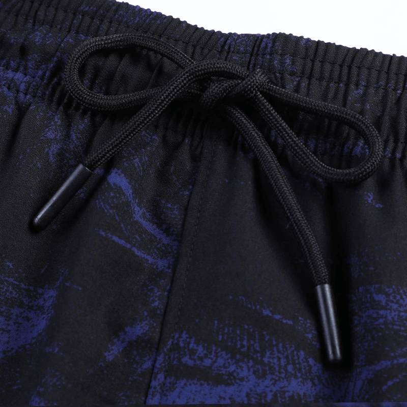 Close-up of camo running shorts waistband in breathable polyester, featuring a drawstring tie for adjustable fit and comfort.