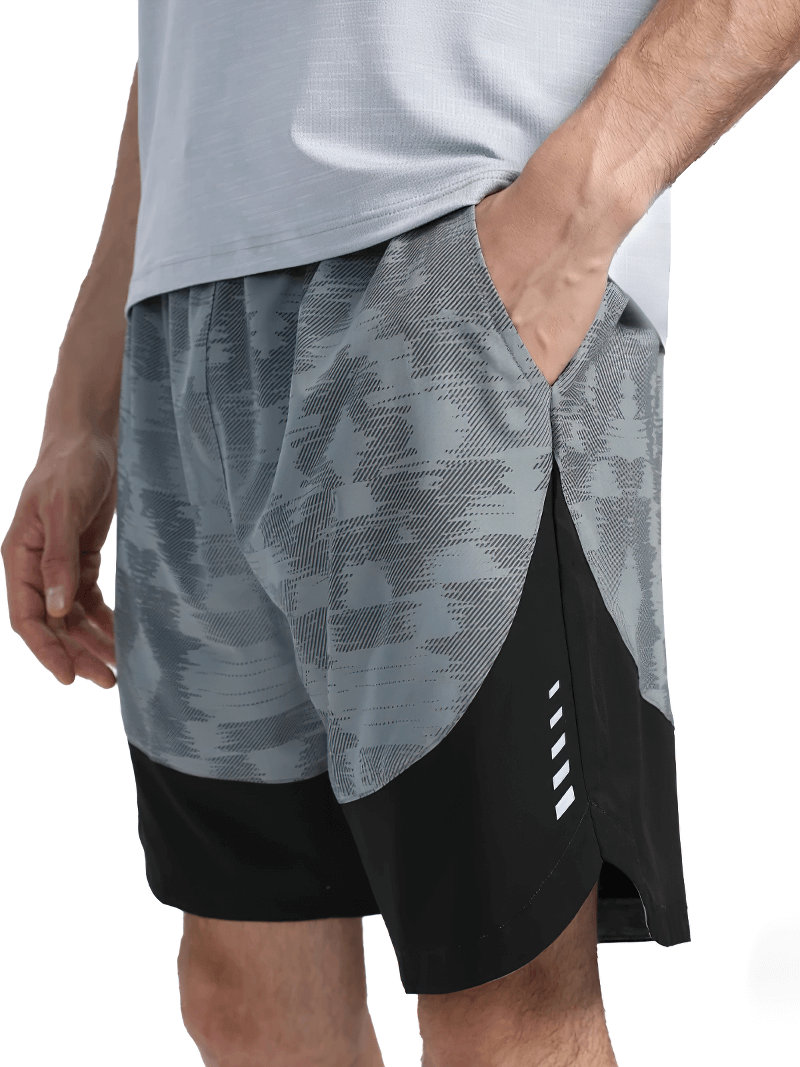 Men's quick-dry camo athletic shorts with pockets and reflective logo, perfect for running and workouts. Elastic waistband and drawstring.