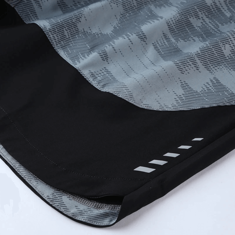 Close-up of camouflage print quick-dry athletic shorts with reflective logo, showcasing breathable fabric and sleek design for running.