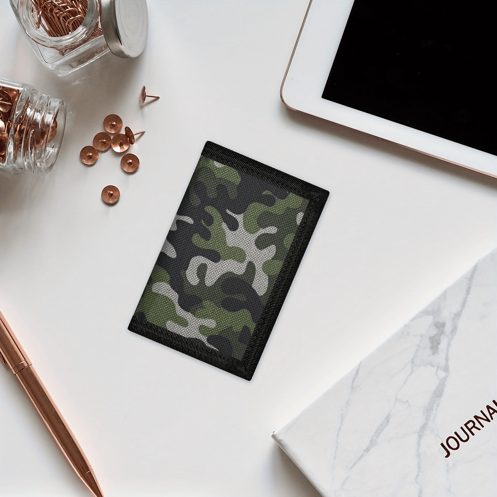 Camo trifold wallet with chain and zip lay on desk with stationery and tablet