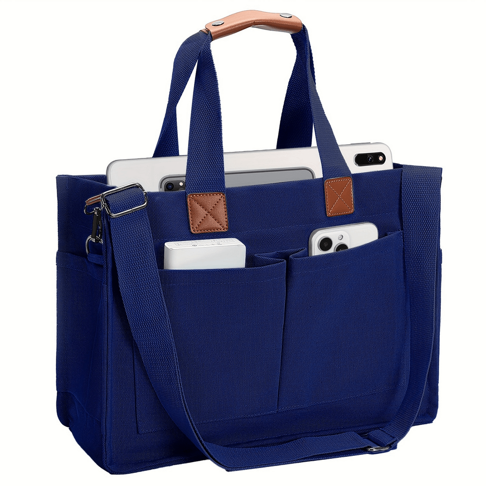 Blue canvas tote bag with adjustable strap, buckle closure, and spacious pockets, perfect for daily use and carry essentials.