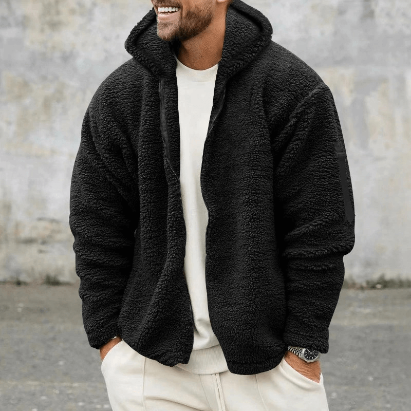 Man wearing black Casual Fleece Zip-up Hooded Loose Jacket, ideal for outdoor activities. Style: SF1897. Cozy and stylish with zipper closure.