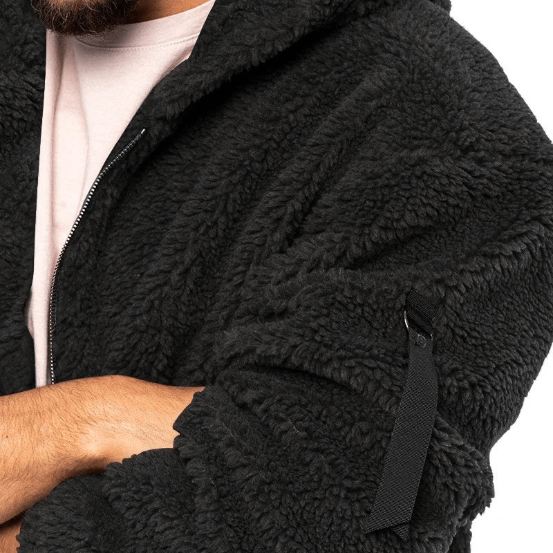 Close-up of black fleece zip-up hooded jacket with unique cuffs for men, perfect for outdoor activities. Cozy and stylish design.
