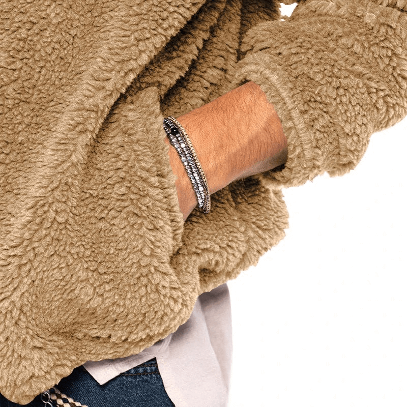 Man wearing a cozy casual fleece zip-up hooded jacket with hand in pocket, showcasing stylish outdoor look.