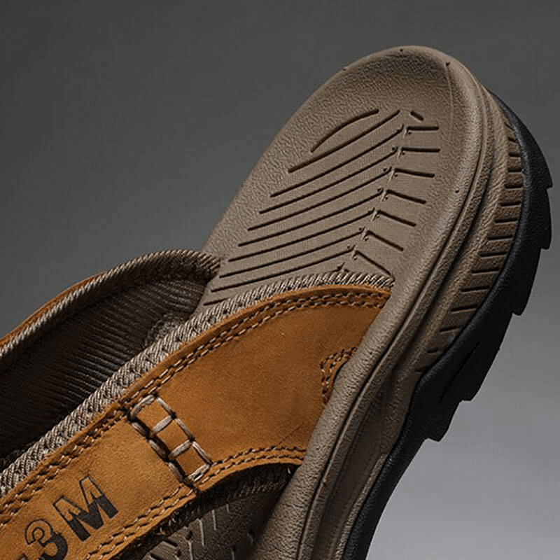 Close-up of casual men's genuine leather anti-slip flip-flops showcasing durable rubber sole and leather details, model SF1068