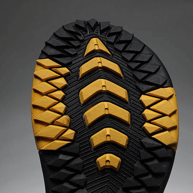 Close-up of yellow and black anti-slip flip flop sole with rugged tread design for durability and style.