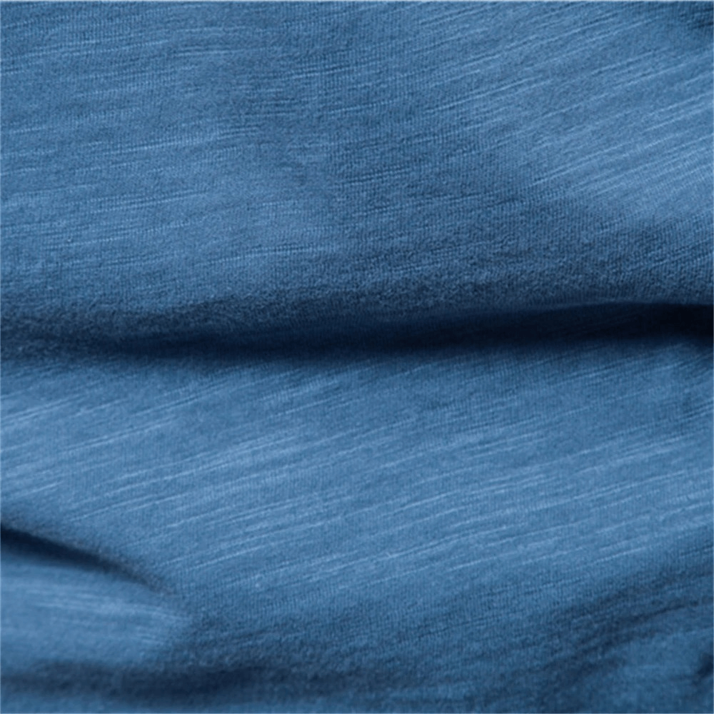 Soft blue fabric texture of a casual solid color sports crew neck T-shirt for men, showcasing its 100% cotton material.