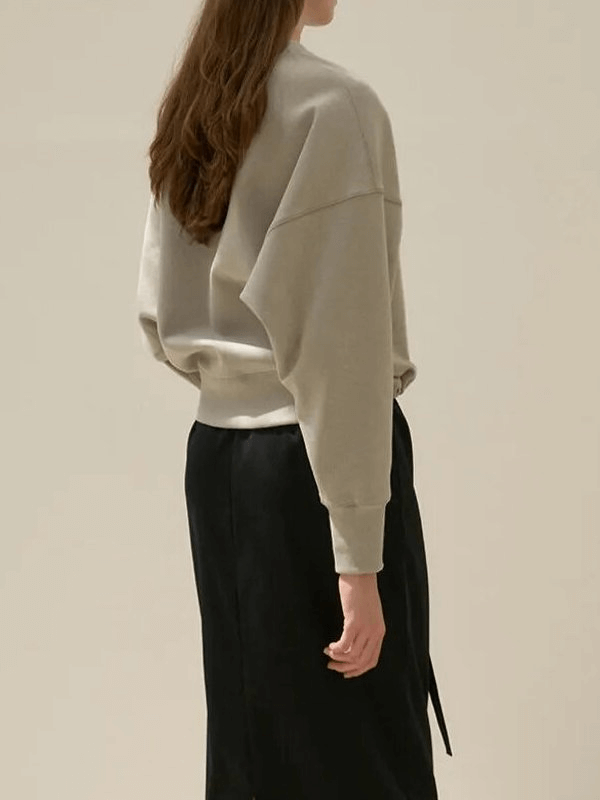 Casual solid women's hoodie, O-neck, loose fit, 100% cotton, modeled from back, paired with black pants, comfy and stylish fashion.