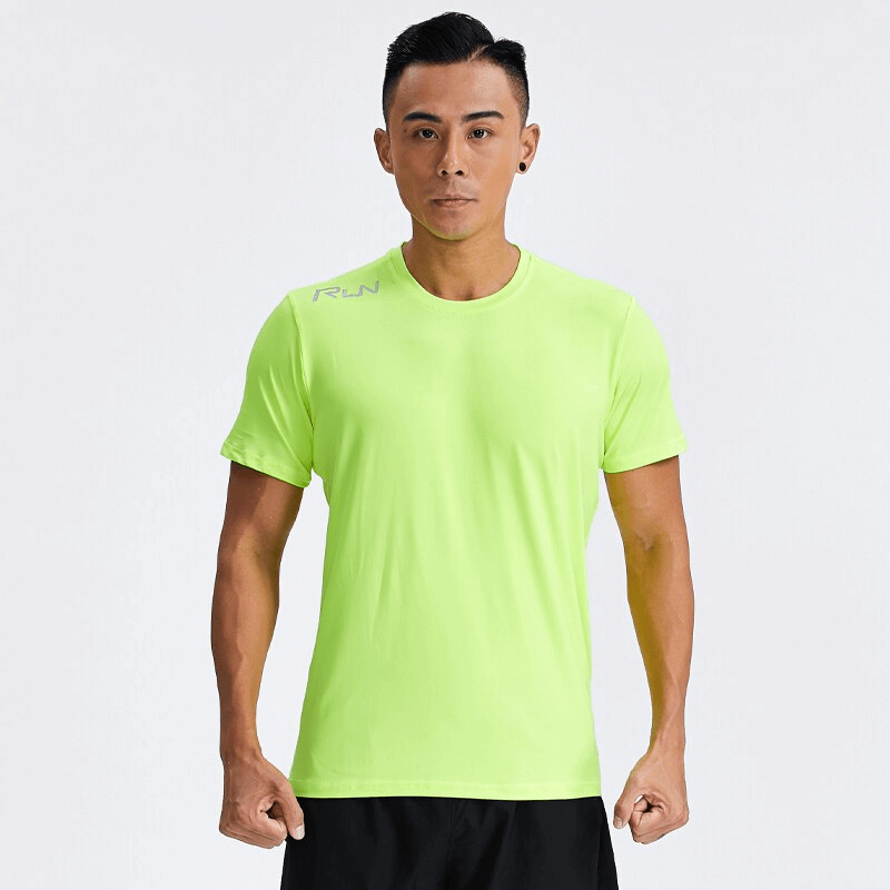 Man wearing neon green quick-dry sport t-shirt with reflective stripes, showcasing breathable and sweat-wicking fabric for active workouts.