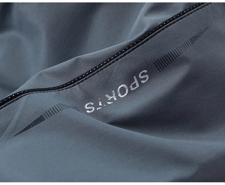Close-up of stylish printed pattern on men's casual zippered track suit jacket, featuring distinct 'SPORTS' lettering.