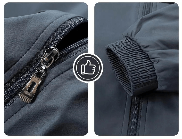 Detail view of men's track suit with zippered closure and elastic cuff, showcasing durable polyester fabric in dark grey.