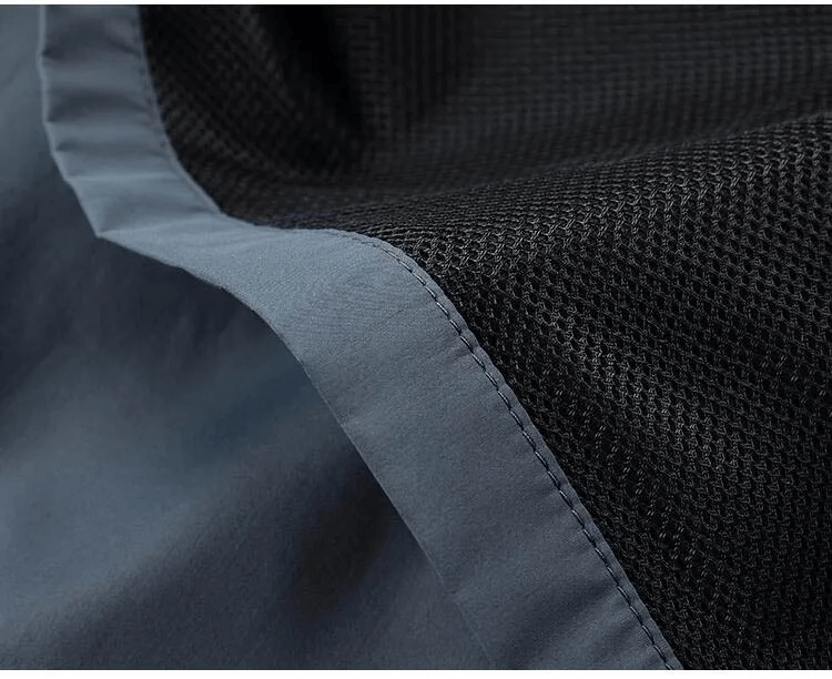 Close-up of black mesh and blue fabric detail on men's casual track suit SF2034.