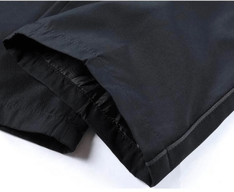 Close-up of black casual track suit fabric showing durable polyester material and stitching.