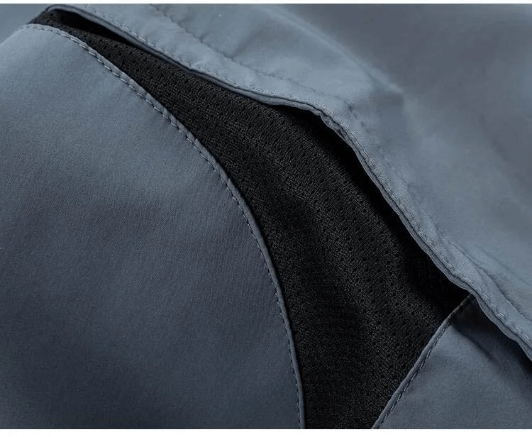 Close-up of blue casual track suit fabric highlighting zippered closure detail.