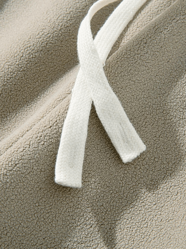 Close-up of drawstring on casual wide fleece sweatpants for men, showcasing soft heavy fleece fabric and detailed texture.