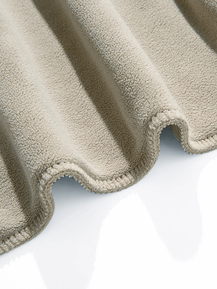 Close-up of soft beige fleece fabric, showcasing texture and warmth for men's casual sweatpants.