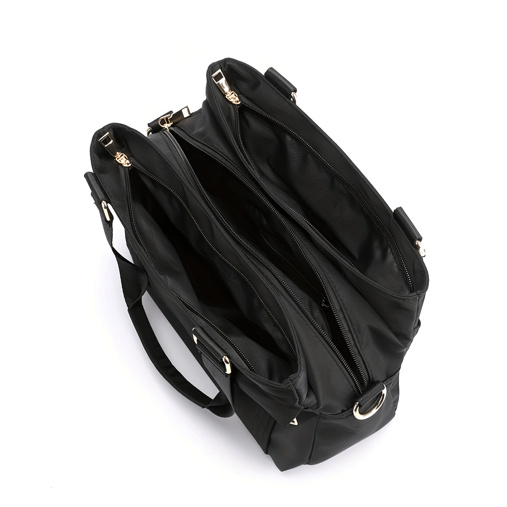 Top view of a large capacity black nylon tote bag with multiple pockets and removable strap for versatile use.