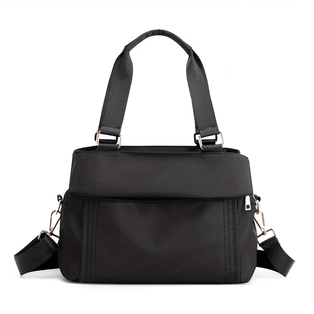 Chic multi-pocket black nylon tote bag with removable strap, ideal for travel and everyday use. Large capacity and water-resistant design.