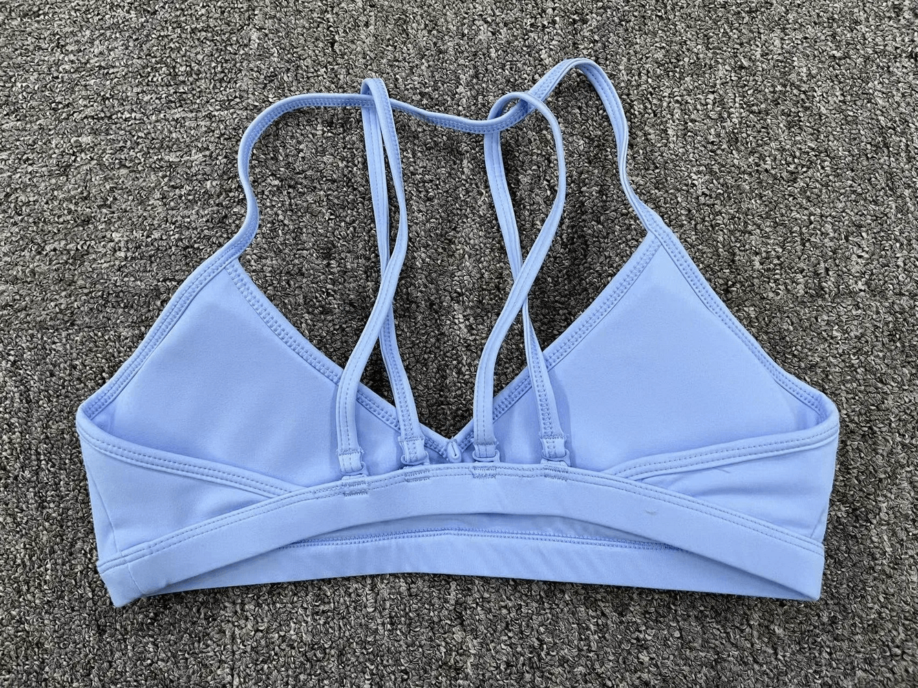Versatile blue sports bra with elegant strappy back design for active wear, ideal for yoga and fitness, SF2468