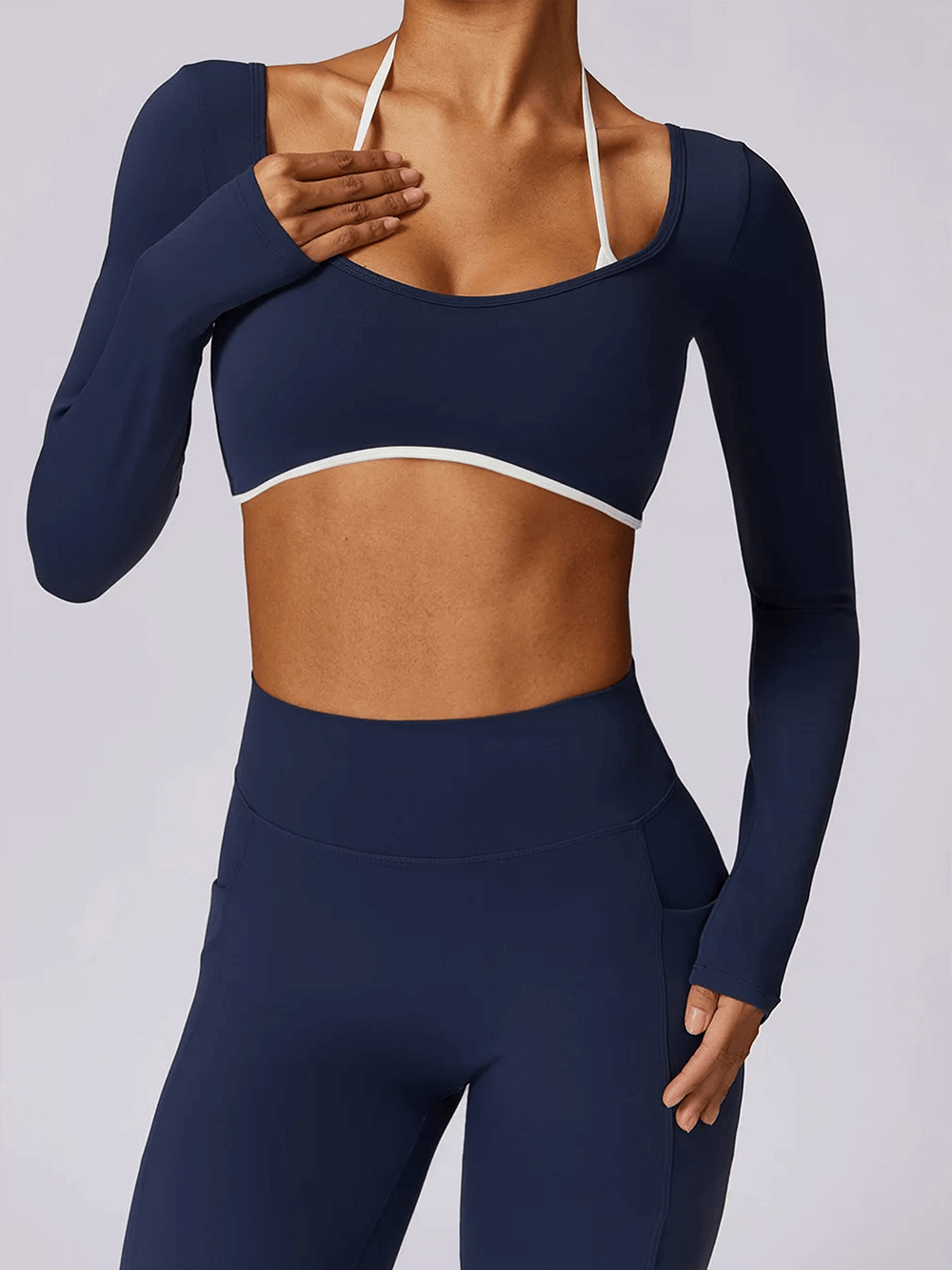 Chic navy nylon yoga set with long-sleeve crop top and high-waist leggings, perfect for women's gym and fitness activities.
