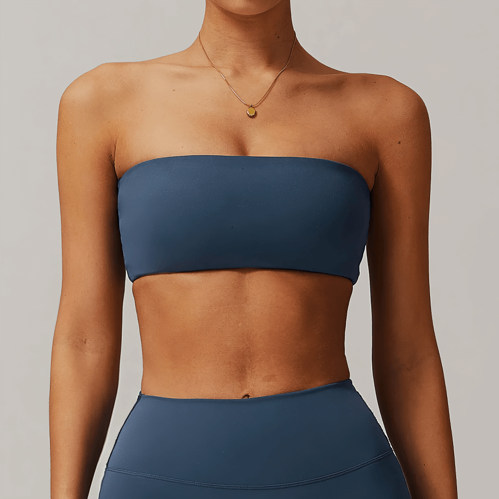 Model wearing a chic strapless crop top in neutral shades, showcasing minimalist design for modern fashion. Perfect for layering.