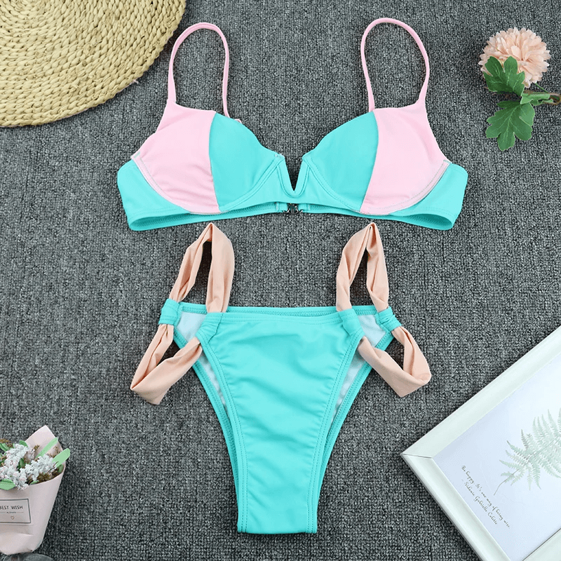 Chic pink and blue bikini set with adjustable straps and high-cut bottoms, ideal swimwear for beach outings and poolside relaxation.