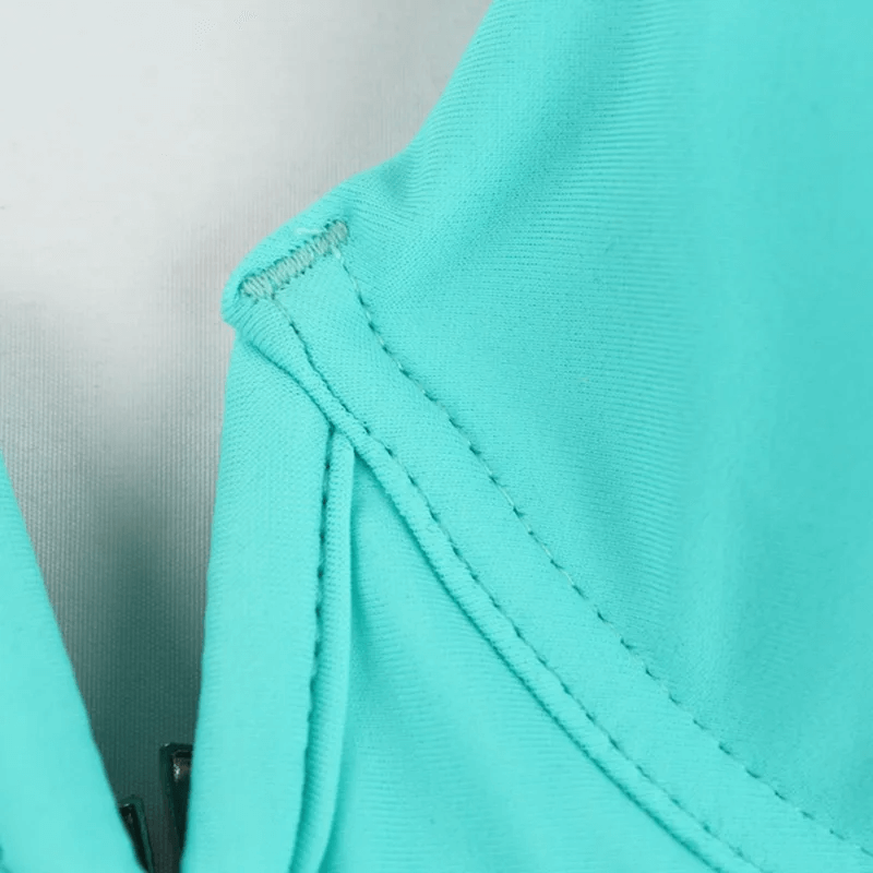 Close-up of mint green fabric from trendy two-tone pink and mint bikini set, showcasing detailed stitching on the swimwear.