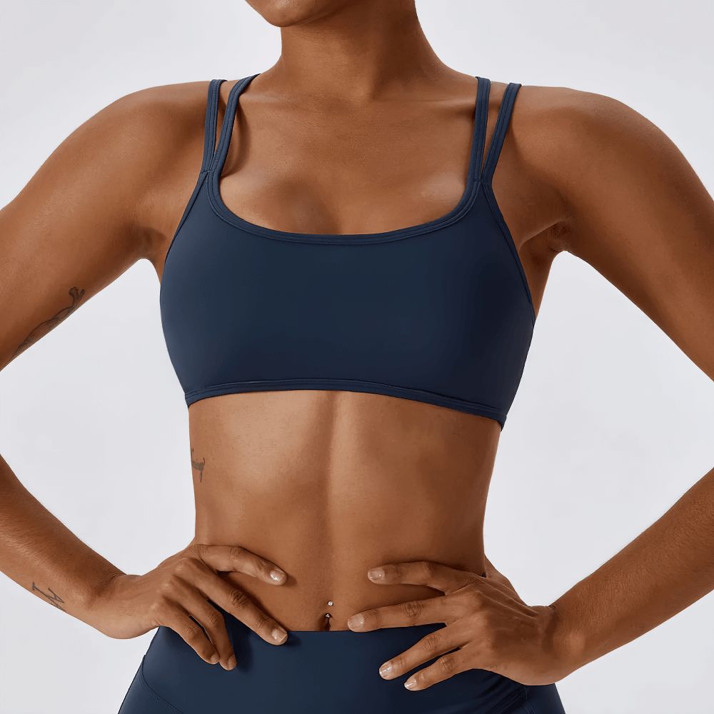 Chic blue women's sports bra with cross-back design for active wear, offering maximum support and freedom of movement during workouts.