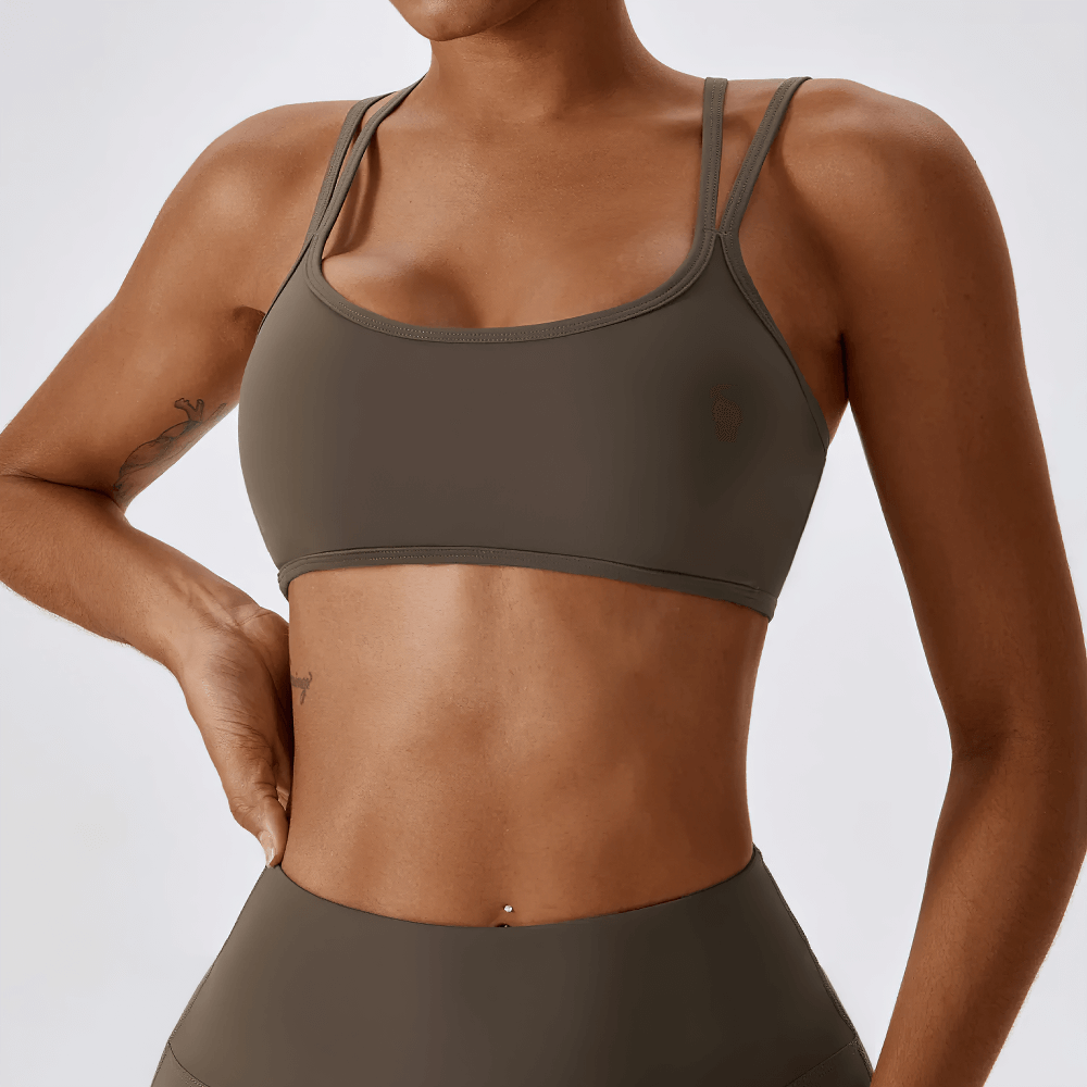 Chic women's sports bra with cross-back design, ideal for active wear. Versatile and stylish, perfect for workouts and casual wear.