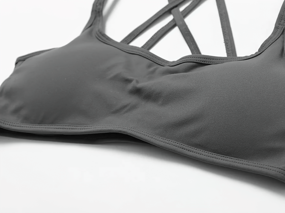 Chic women's sports bra with a sleek cross-back design, providing support and style for active wear.