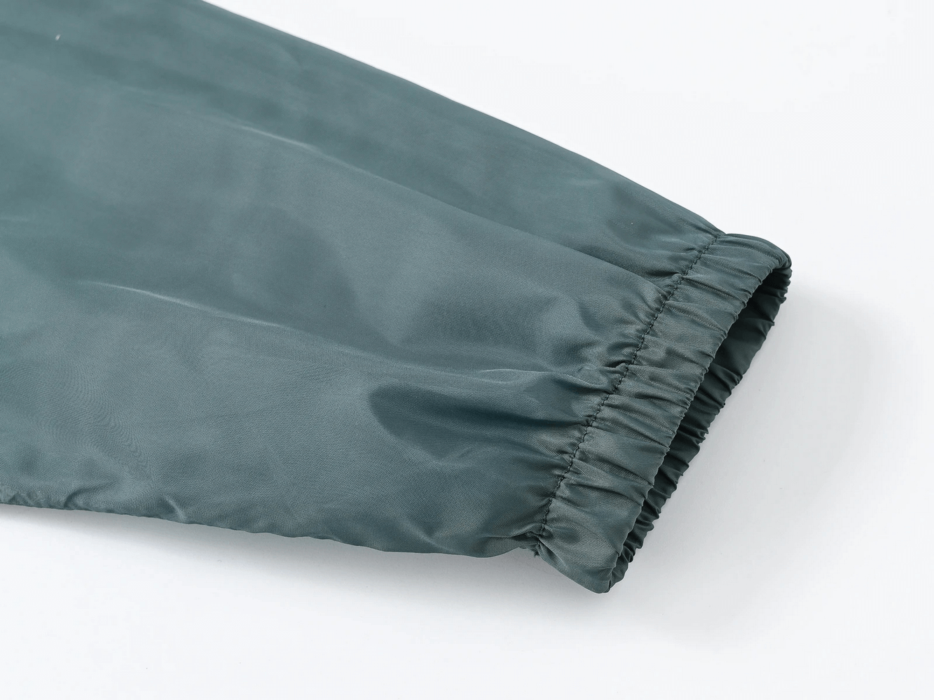 Close-up of sleeve on Children's Rainbow Zipper Hooded Jacket - SF3639, showing elastic cuff and smooth, lightweight fabric.