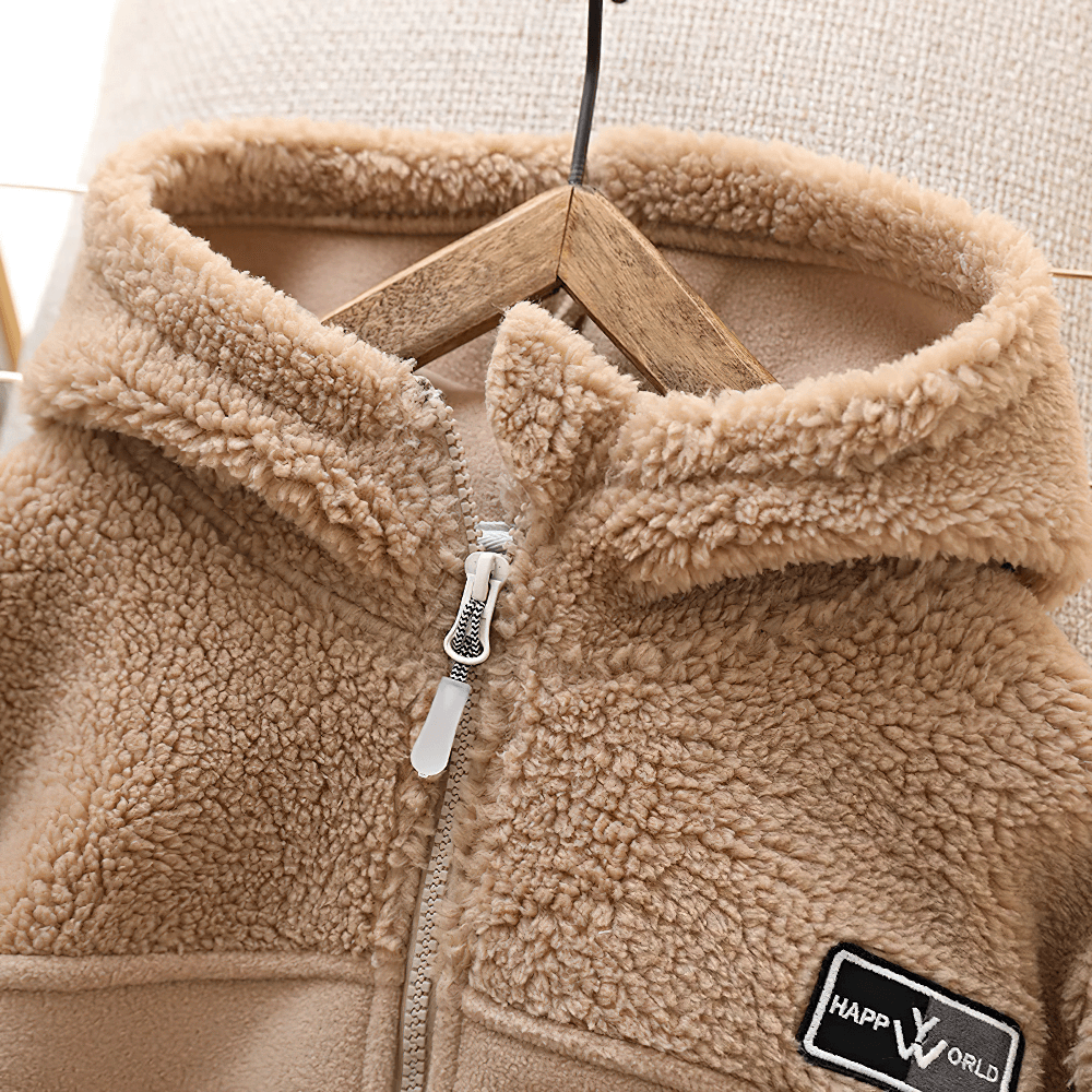Children's Thickened Fleece Hooded Jacket - SF3595 hanging on a wooden hanger, showcasing the cozy tan fleece and secure zip closure.