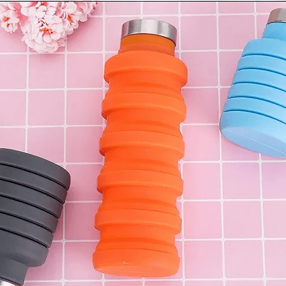 Collapsible Silicone Water Bottle for Hiking - SF3485 in vibrant colors with stainless-steel lid on a pink tile background.