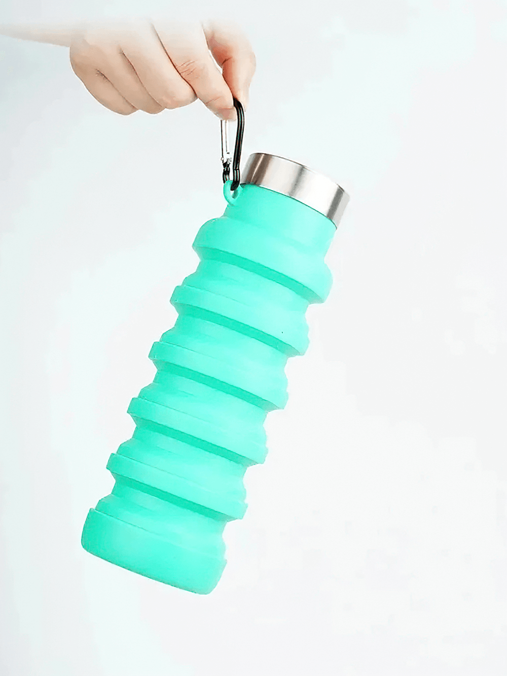Hand holding the Collapsible Silicone Water Bottle for Hiking - SF3485 with stainless-steel lid