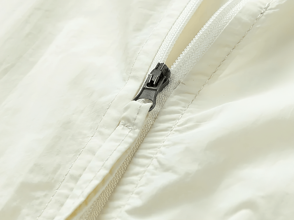 Color Block Hooded Windbreaker Jacket with Pockets - SF4725 close-up of zipper detail on cream fabric.