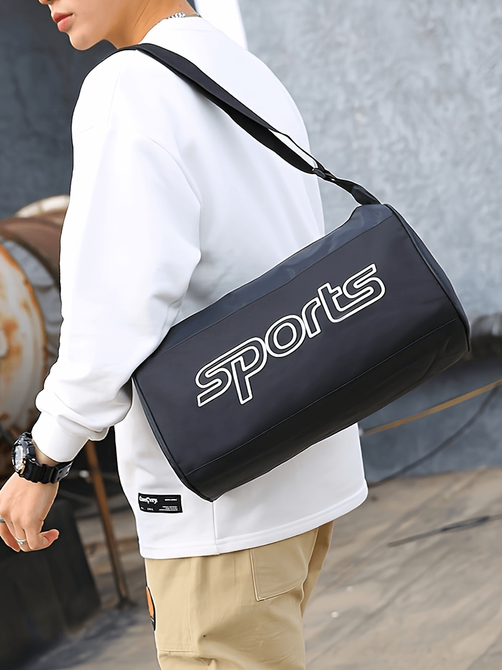 Person carrying a colorblock sports shoulder bag with bold letter pattern and adjustable strap, ideal for gym essentials.