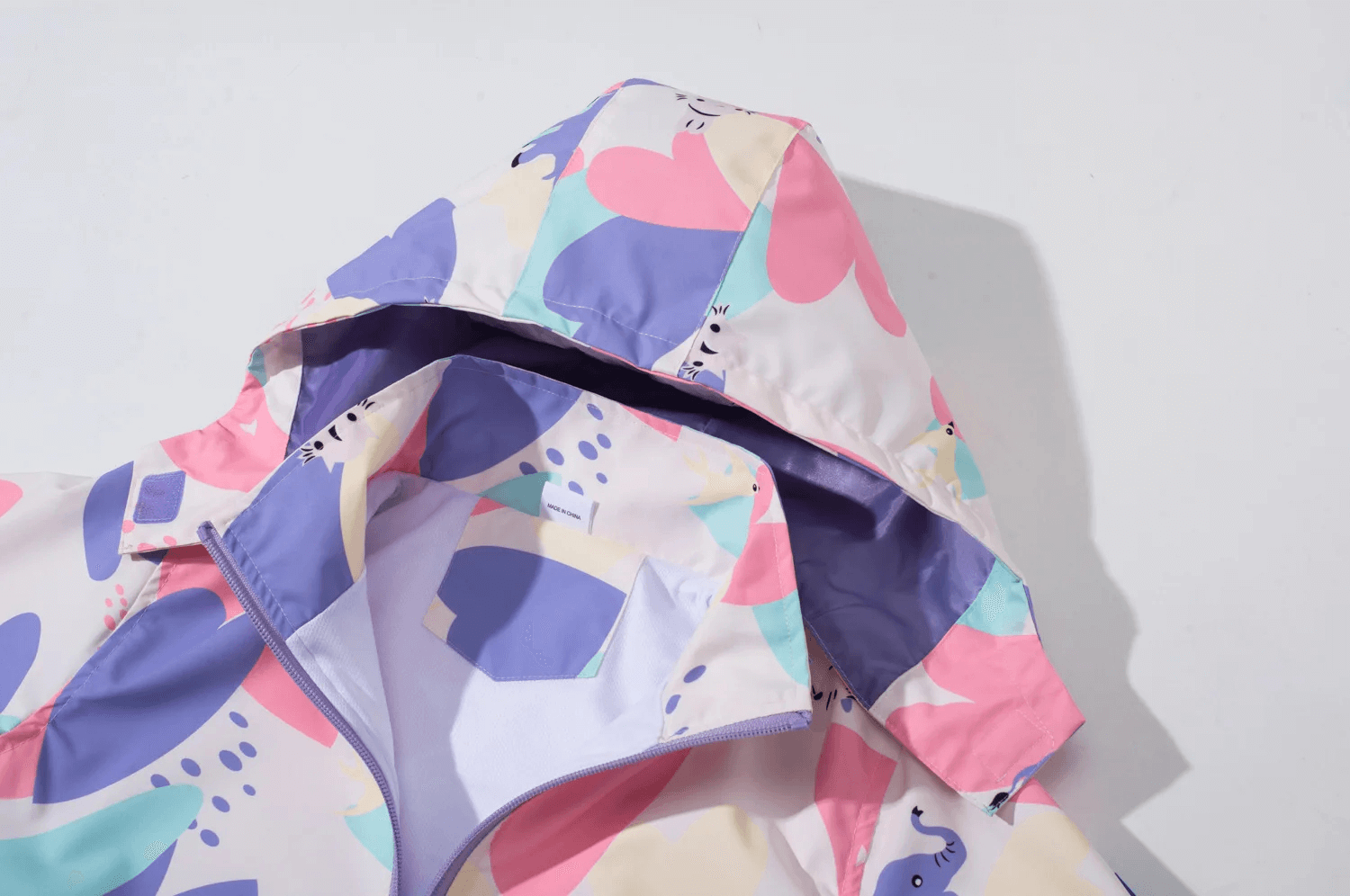 Colorful Elephant Print Waterproof Zip Jacket - SF3596 with detachable hood and zip closure, showcasing vibrant kids' rainwear.