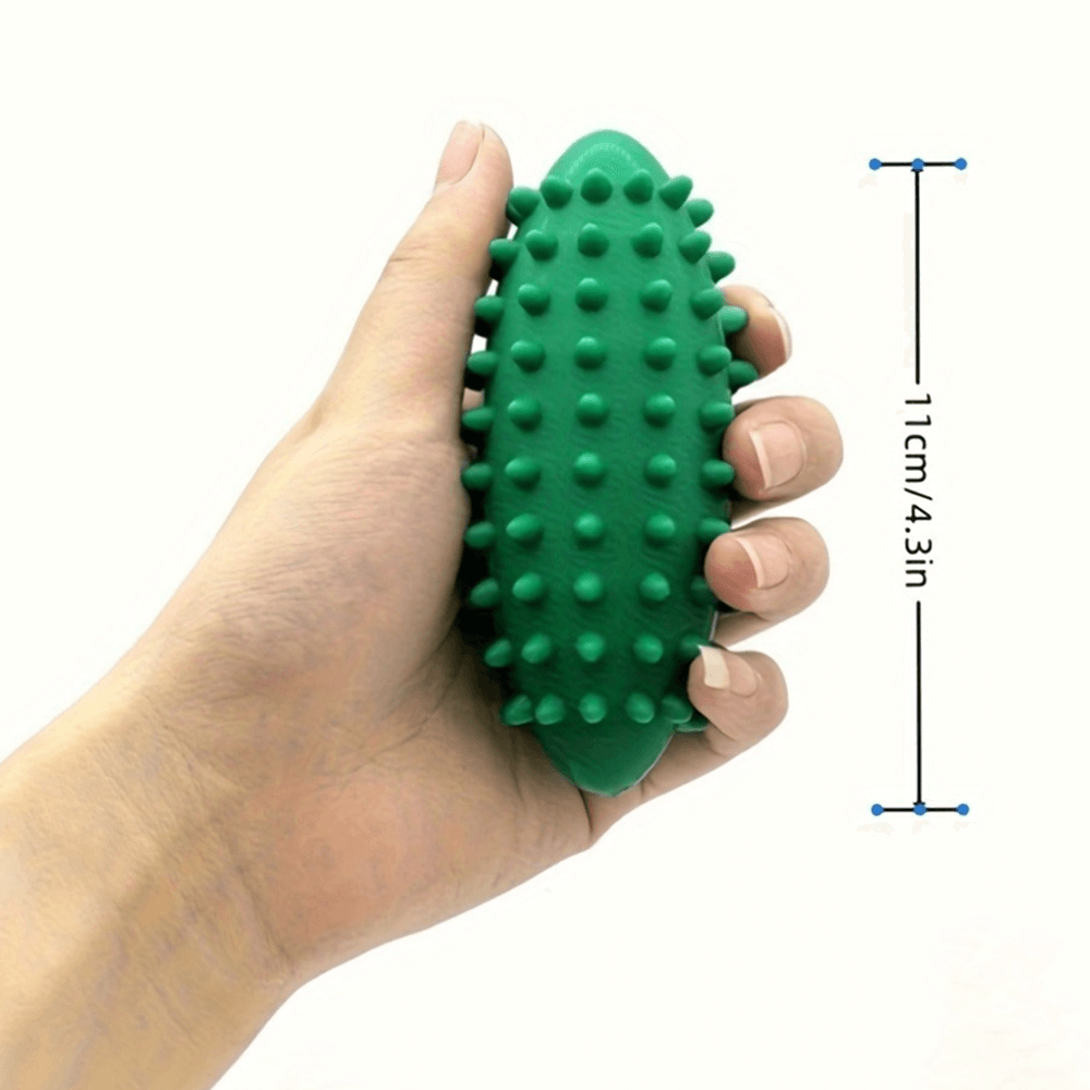 Hand holding green spiked massage ball for stress relief and muscle tension, shown with dimensions 11cm/4.3in.