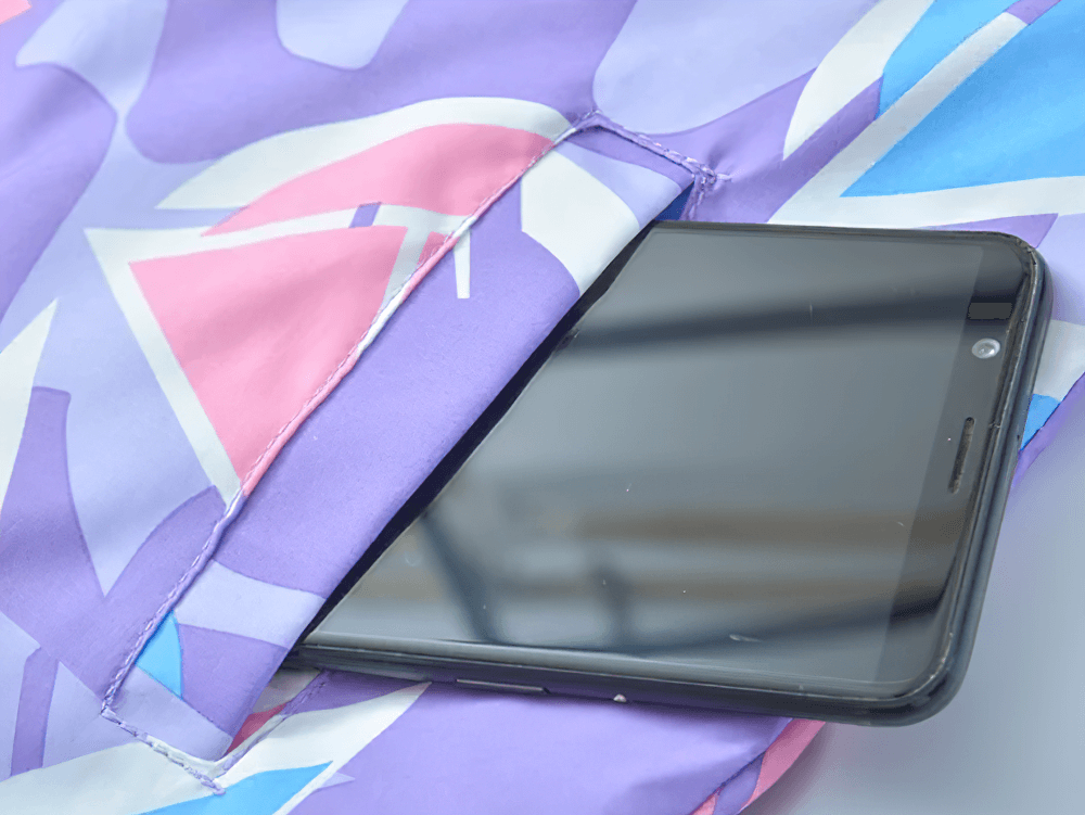 Colorful Windbreaker Jacket with Fleece Lining - SF3579 pocket detail with geometric design and smartphone stored inside.