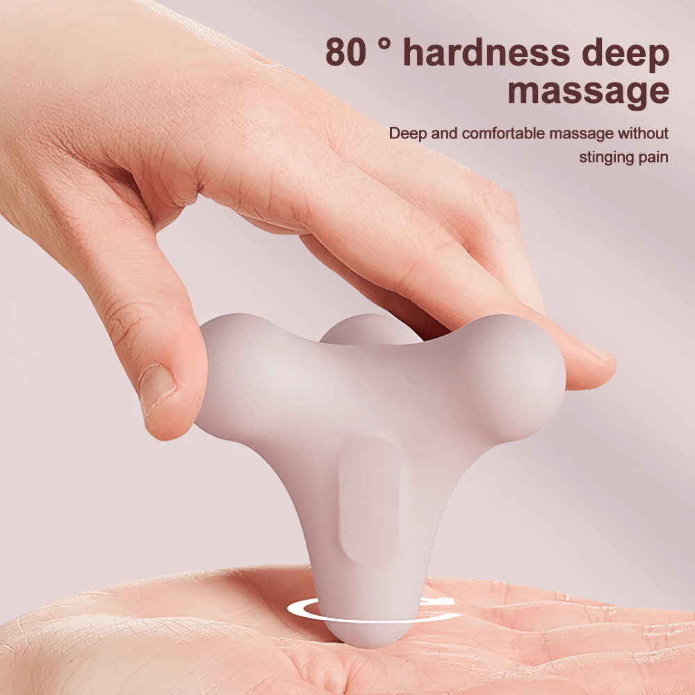 Close-up of a hand holding a compact 3D massage ball for deep muscle relaxation, showcasing its ergonomic design.