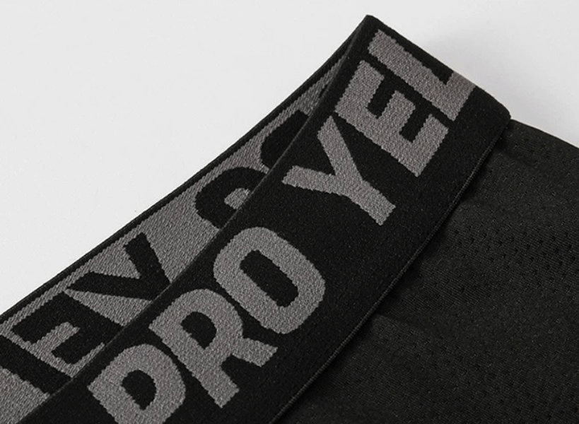 Close-up of black elastic waistband with gray text on Compression Men's Performance Running Tights, model SF2177.
