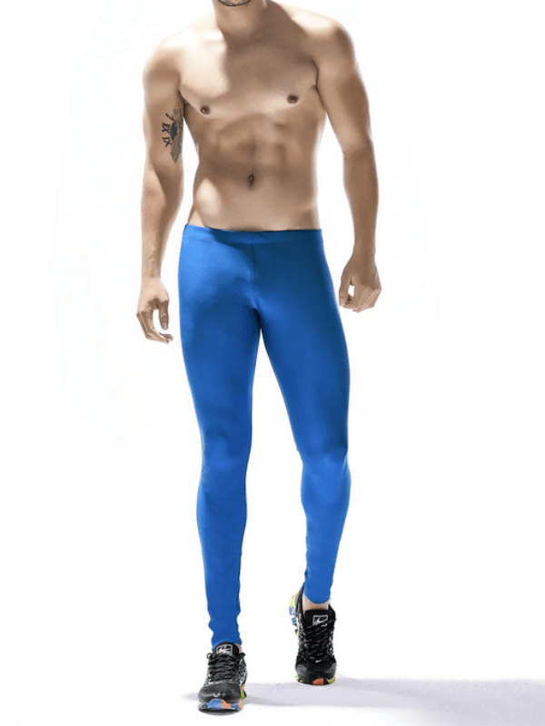 Man wearing blue compression quick-drying tights for training, showcasing patchwork design and flexible fit for running.